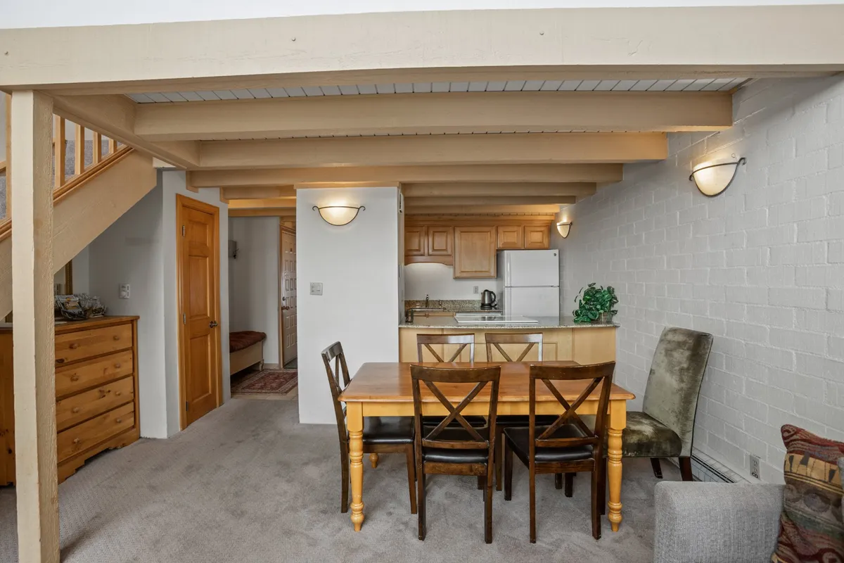 An open-concept area where the dining table sits adjacent to the kitchen and living space. The layout encourages mingling while dining or preparing food, with sightlines connecting the dining table, sofa, and kitchen. The atmosphere is relaxed and welcoming, ideal for family feasts or casual gatherings with friends.
